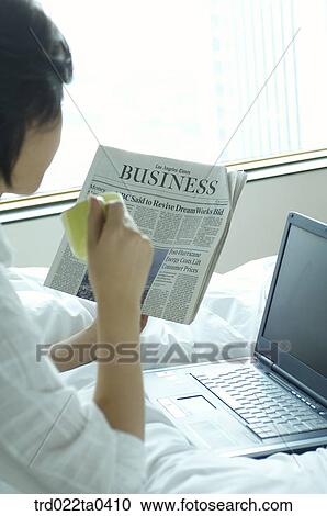 a woman reading a newspaper and a drinking a tea View Large Photo Image Stock Image - a woman reading a newspaper and a drinking a tea. Fotosearch