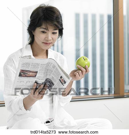 a woman reading a newspaper on a bed View Large Photo Image Stock Image - a woman reading a newspaper on a bed. Fotosearch