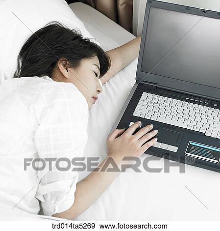 Stock Photo - a woman sleeping on a bed. Fotosearch