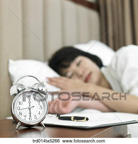 a woman sleeping on a bed View Large Photo Image Stock Photograph - a woman sleeping on a bed. Fotosearch