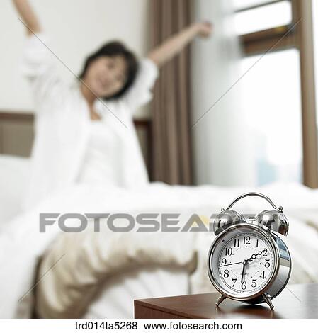 Stock Photo - a woman straightening her back. Fotosearch