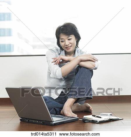 a woman with her arms folded on a floor View Large Photo Image Stock Image - a woman with her arms folded on a floor. Fotosearch