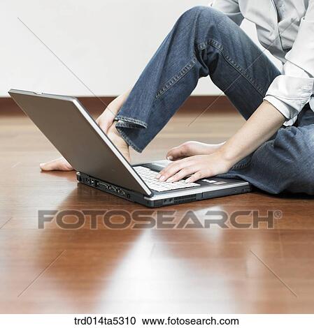 a woman working with a notebook on a floor View Large Photo Image Stock Image - a woman working with a notebook on a floor. Fotosearch