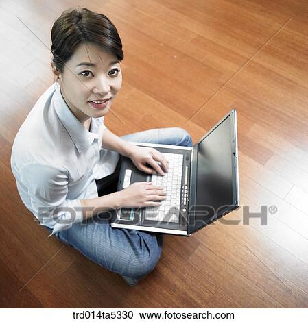 a woman working with a notebook on a floor View Large Photo Image Stock Image - a woman working with a notebook on a floor. Fotosearch