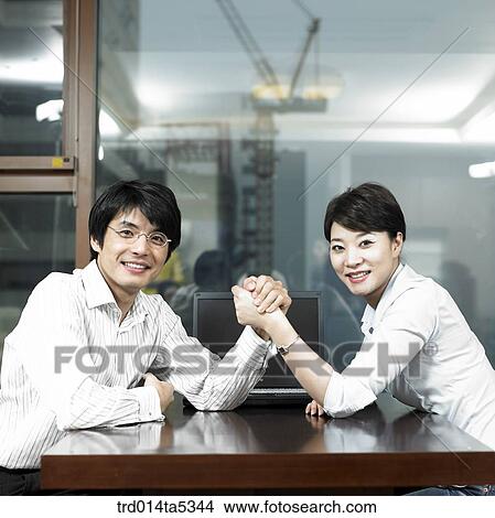 an arm-wrestling businessman and a businesswoman View Large Photo Image Picture - an arm-wrestling businessman and a businesswoman . Fotosearch