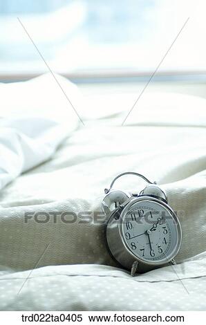 bedcloas amd an alarm clock View Large Photo Image Stock Photography - bedcloas amd an alarm clock. Fotosearch