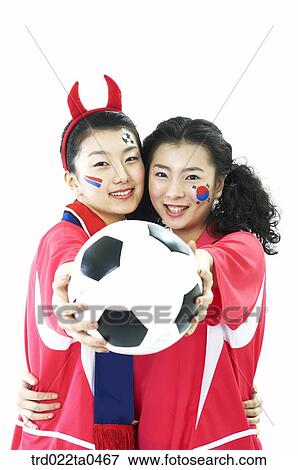 Stock Photo - a ball and two supporters. Fotosearch