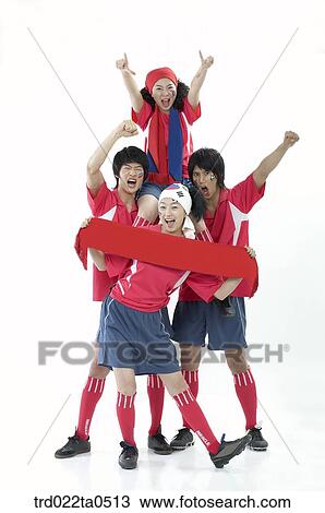 Stock Image - a cheering group of supporters holding a towel. Fotosearch
