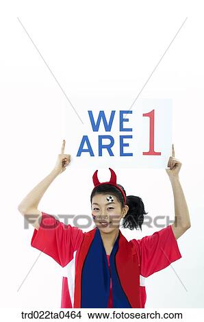 Picture - a cheering supporter holding a flag card. Fotosearch