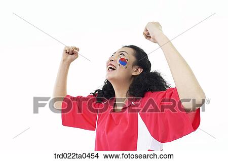 a cheering supporter holding her hands high View Large Photo Image Picture - a cheering supporter holding her hands high. Fotosearch