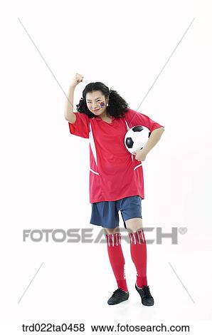 Stock Photo - a cheering supporter holding her hands high. Fotosearch