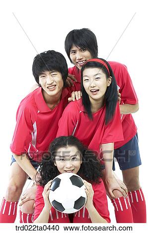 Stock Image - a group of supporters holding a ball. Fotosearch
