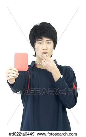 Stock Photo - a judge holding a red card and blowing a whistle. Fotosearch