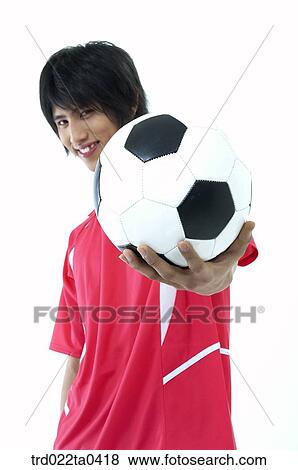 a soccer player holding a ball View Large Photo Image Stock Photo - a soccer player holding a ball. Fotosearch