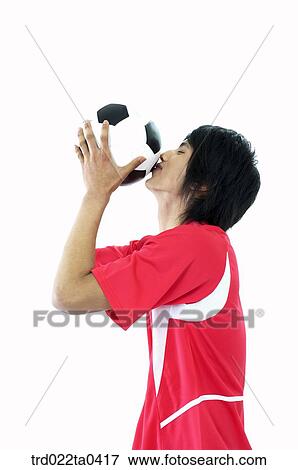 a soccer player kissing a ball View Large Photo Image Stock Photo - a soccer player kissing a ball. Fotosearch
