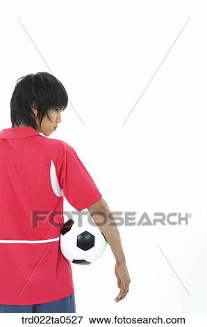 a soccer player's back holding a ball View Large Photo Image Stock Photo - a soccer player's back holding a ball. Fotosearch