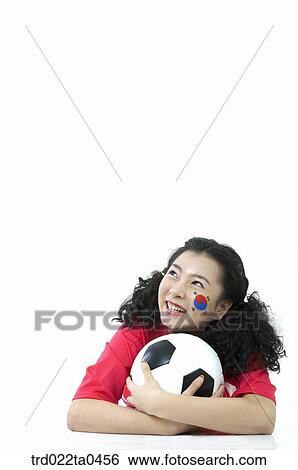 Stock Photograph - a supporter and a ball. Fotosearch
