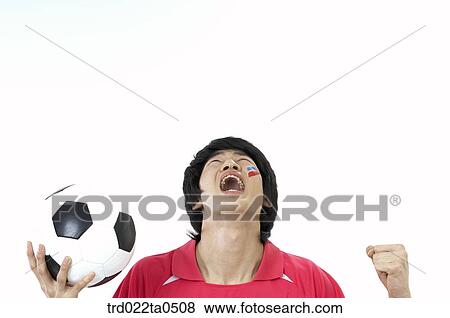 a supporter holding a ball high View Large Photo Image Stock Photo - a supporter holding a ball high. Fotosearch