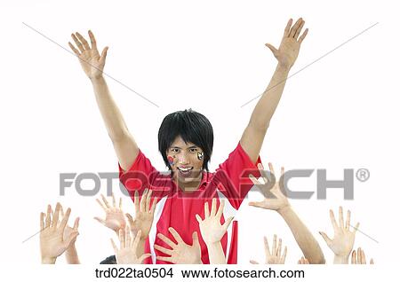 a supporter holding their hands high and others' hands View Large Photo Image Picture - a supporter holding their hands high and others' hands. Fotosearch