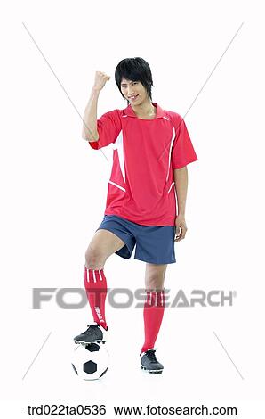 a supporter stepping on a ball and clenching his fists View Large Photo Image Stock Photograph - a supporter stepping on a ball and clenching his fists. Fotosearch