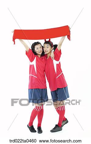 two cheering supporters holding a towel View Large Photo Image Stock Image - two cheering supporters holding a towel. Fotosearch