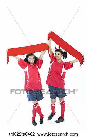 Stock Image - two cheering supporters holding a towel. Fotosearch