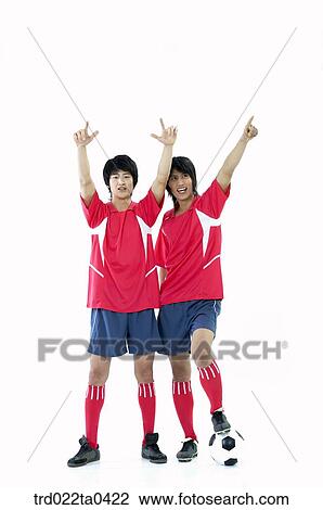 Stock Image - two men holding their hands high. Fotosearch