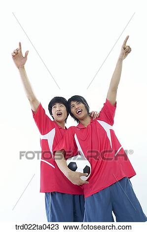 two men holding their hands with a ball high View Large Photo Image Stock Image - two men holding their hands with a ball high. Fotosearch