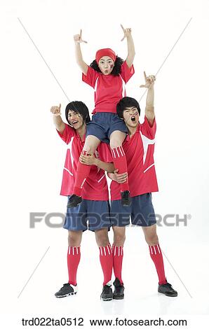 Stock Image - two supporters giving one supporter a ride. Fotosearch
