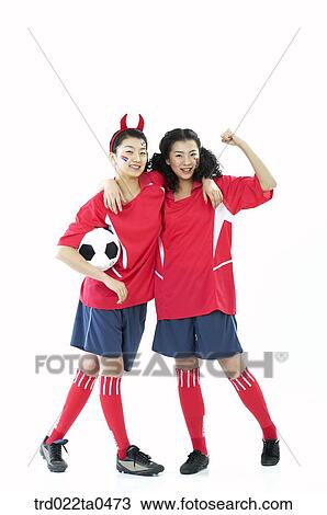 Stock Image - two supporters holding a ball. Fotosearch