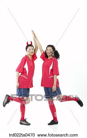 two supporters slapping high-fives View Large Photo Image Stock Image - two supporters slapping high-fives. Fotosearch