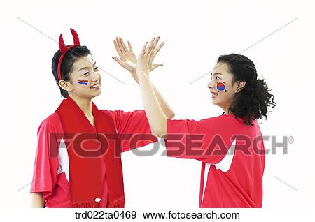 two supporters slapping high-fives View Large Photo Image Stock Photo - two supporters slapping high-fives. Fotosearch