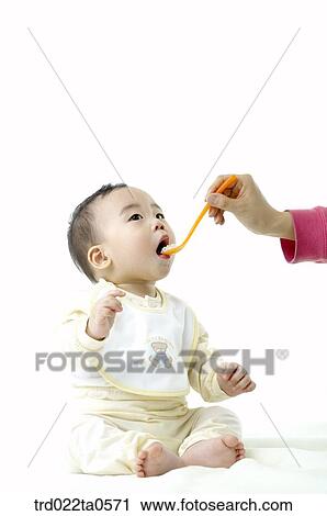 a baby eating baby food View Large Photo Image Stock Image - a baby eating baby food. Fotosearch