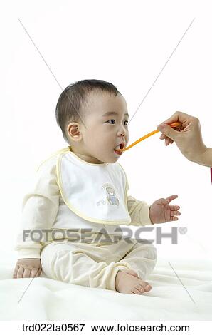 a baby eating baby food View Large Photo Image Stock Photo - a baby eating baby food. Fotosearch