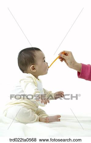 a baby eating baby food View Large Photo Image Stock Photo - a baby eating baby food. Fotosearch