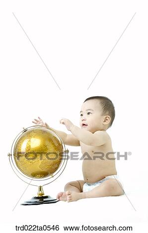Stock Photograph - a baby in front of a globe. Fotosearch