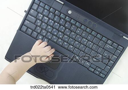 a baby in front of a notebook View Large Photo Image Stock Image - a baby in front of a notebook. Fotosearch