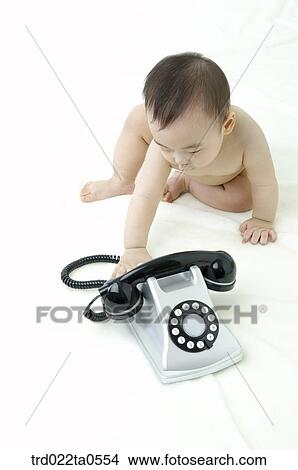 a baby in front of a telephone View Large Photo Image Picture - a baby in front of a telephone. Fotosearch