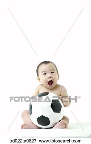 a baby playing a soccer ball View Large Photo Image Stock Photo - a baby playing a soccer ball. Fotosearch