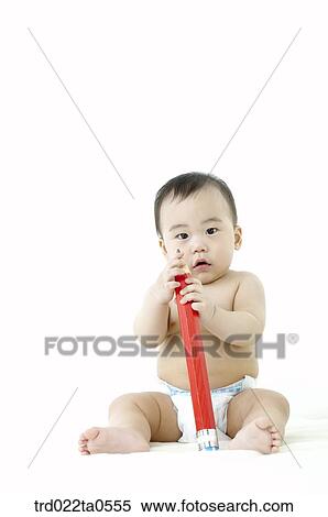 a baby playing a toy View Large Photo Image Stock Photography - a baby playing a toy. Fotosearch