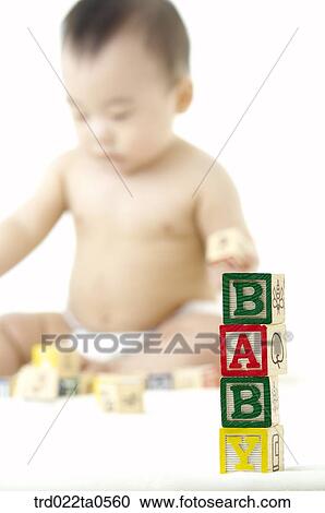 Stock Image - a baby playing blocks. Fotosearch
