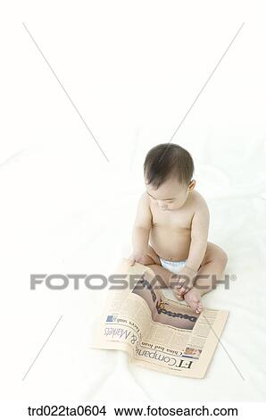 a baby reading a newspaper View Large Photo Image Picture - a baby reading a newspaper. Fotosearch