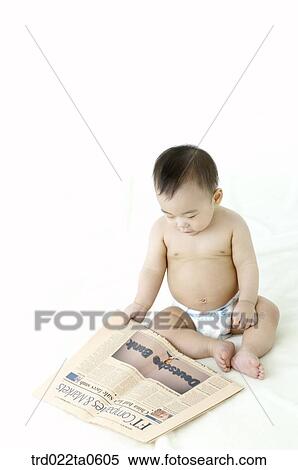 Stock Photography - a baby reading a newspaper. Fotosearch