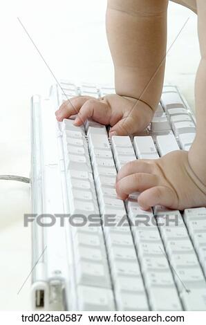 Stock Photo - a baby using a keyboard. Fotosearch