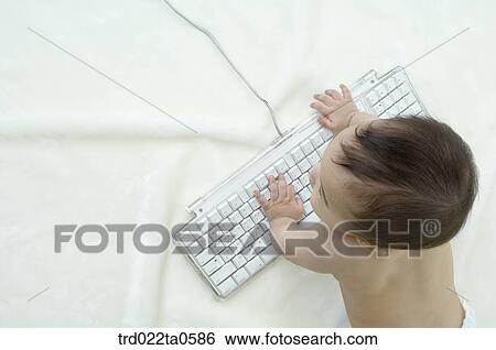 Stock Photograph - a baby using a keyboard. Fotosearch
