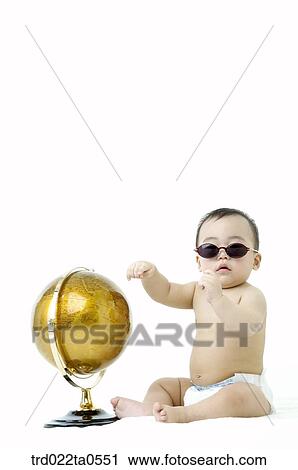 a baby wearing sunglasses in front of a globe View Large Photo Image Stock Image - a baby wearing sunglasses in front of a globe. Fotosearch