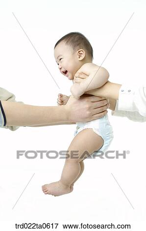 Stock Photo - a baby with his parents. Fotosearch