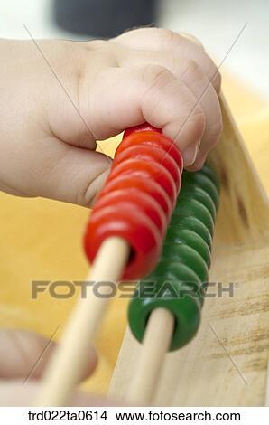a baby's hand with a toy View Large Photo Image Picture - a baby's hand with a toy. Fotosearch