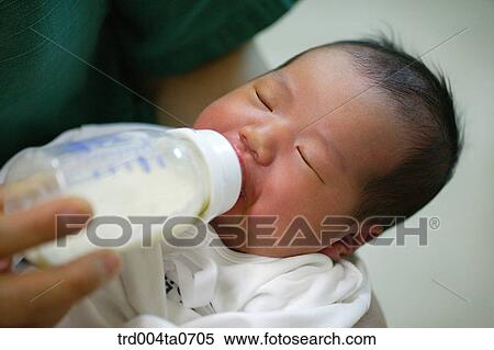 a newborn baby sucking a nursing bottle View Large Photo Image Stock Photography - a newborn baby sucking a nursing bottle. Fotosearch