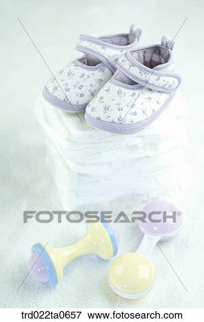 baby supplies/a baby shoe and a noisemaker View Large Photo Image Stock Photo - baby supplies/a baby shoe and a noisemaker. Fotosearch
